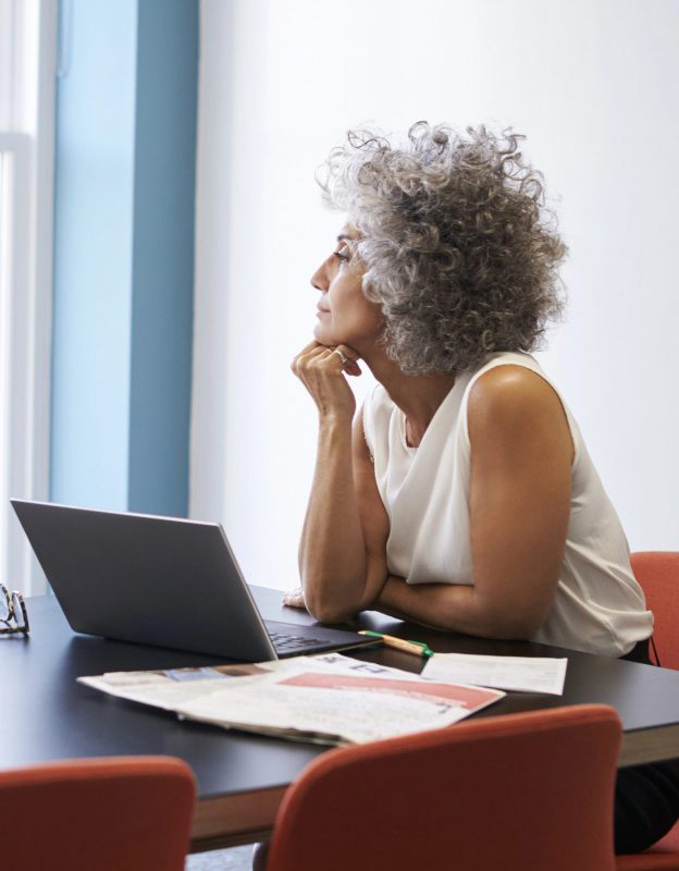 A women with a laptop computer looking out of a window