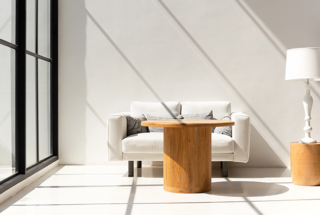 Cozy sunlight coming through large windows into a living room